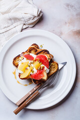 French toast with cream and citrus slices.