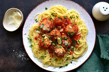 Spaghetti pasta with meatballs in tomato sauce. Traditional dish of italian cuisine. Top view with copy space.