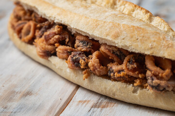 Calamari or squid rings baguette , close up