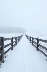 A wooden fence leading into a snowy field with a large empty white area