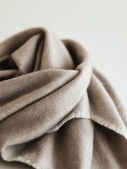 Soft wool blanket folded on neutral background creating cozy atmosphere