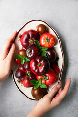 High-resolution image of fresh, juicy red tomatoes with water droplets on a clean background. This photo is perfect for promoting organic produce, healthy food, or farm-to-table concepts. 
