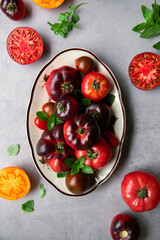 High-resolution image of fresh, juicy red tomatoes with water droplets on a clean background. This photo is perfect for promoting organic produce, healthy food, or farm-to-table concepts. 