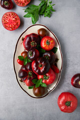High-resolution image of fresh, juicy red tomatoes with water droplets on a clean background. This photo is perfect for promoting organic produce, healthy food, or farm-to-table concepts. 