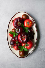 High-resolution image of fresh, juicy red tomatoes with water droplets on a clean background. This photo is perfect for promoting organic produce, healthy food, or farm-to-table concepts. 