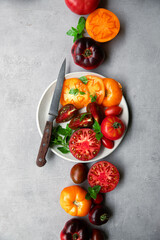 High-resolution image of fresh, juicy red tomatoes with water droplets on a clean background. This photo is perfect for promoting organic produce, healthy food, or farm-to-table concepts. 