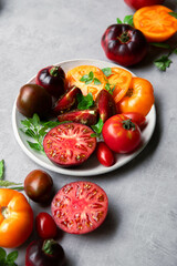 High-resolution image of fresh, juicy red tomatoes with water droplets on a clean background. This photo is perfect for promoting organic produce, healthy food, or farm-to-table concepts. 
