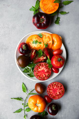 High-resolution image of fresh, juicy red tomatoes with water droplets on a clean background. This photo is perfect for promoting organic produce, healthy food, or farm-to-table concepts. 