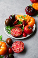 High-resolution image of fresh, juicy red tomatoes with water droplets on a clean background. This photo is perfect for promoting organic produce, healthy food, or farm-to-table concepts. 