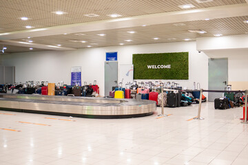 Suitcase or luggage on conveyor belt in the international airport. Copy space. Arrival and baggage claim area