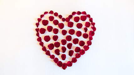 A heart made of red flowers, meticulously arranged, symbolizes love and passion.