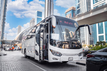 Dubai, UAE. White tourist bus on a city street.  © Sergey