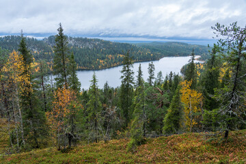 A view to a rocky hill, forests and a lake from the slope of Valtavaara near Kuusamo, Northern Finland