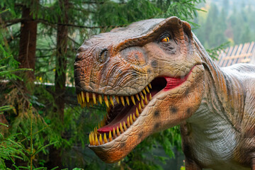 Close up of a dinosaur in the forest. Dinosaurs Park