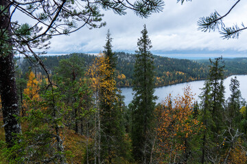 A view to a rocky hill, forests and a lake from the slope of Valtavaara near Kuusamo, Northern Finland