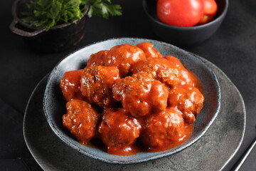 meatballs with tomato sauce and decorated with parsley