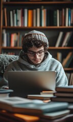 Young man working on laptop in library.