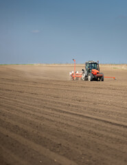 Obraz premium Tractor and seeder for sowing corn