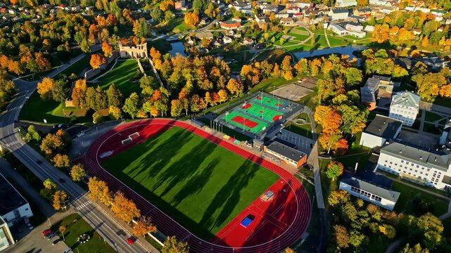 Dobele Stadium Near Dobele Castle Ruins During Autumn In Latvia. aerial shot