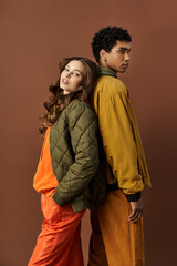 This stylish couple showcases their trendy autumn outfits, blending colors and textures beautifully.
