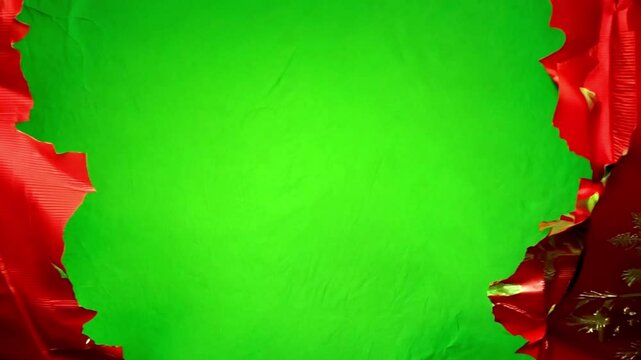 Unwrapping Christmas wrapping paper on green screen. Unwrapping gift revealing a green screen. Craft paper gift wrapping, Christmas holiday concept. Copy space