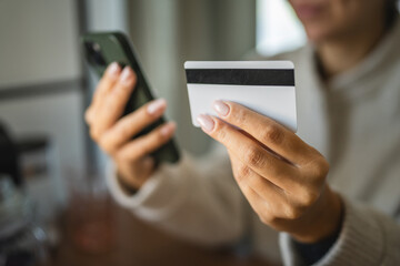 Adult woman use smart phone for online shopping transaction safely