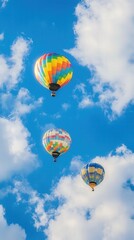 Obraz premium Colorful hot air balloons ascend into a bright sky filled with fluffy clouds during a sunny day