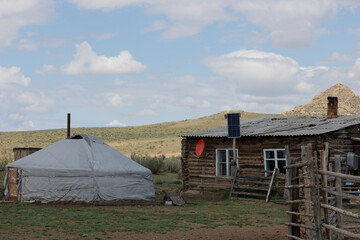Yurt and old wooden house. Cattlemen's dwelling. Republic of Tyva