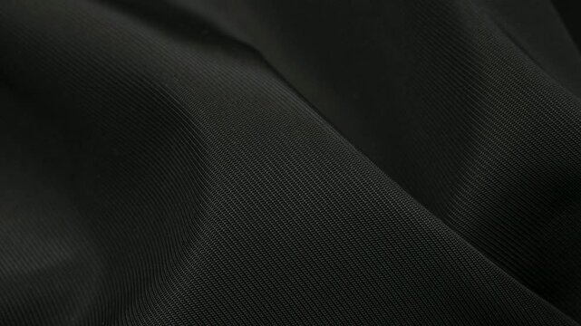  black crinkled material with visible details. background