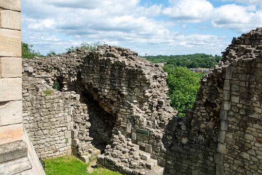 Yorkshire, UK &ndash; 23 July 2024: A gap in the old stone curtain wall at Conisbrough Castle reveals their depth and the strength of their construction