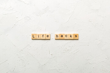 life hacks word written on wood block. life hacks text on table, concept © sosiukin