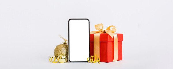 Digital phone mock up with rustic Christmas decorations for app presentation with empty space for you design. Christmas online shopping concept. Tablet with copy space on colored background