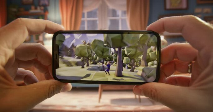 A person is holding a cell phone up to their eye, looking at a video game