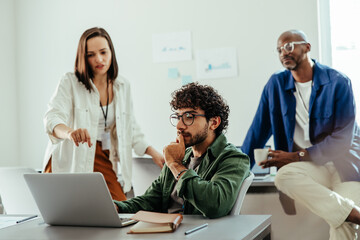 Focused business team collaborating on a project at the office