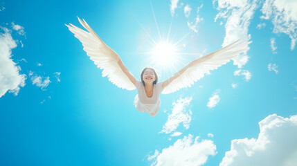 Freedom and setting free concept. A happy Asian woman with white wings spreading them out ready to freely fly up into the blue sky