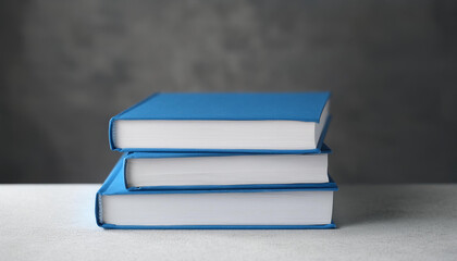 Stack of 3 books with blank hard covers on cement table. Mock-up.