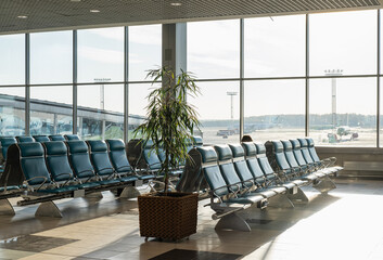 Waiting area with blue seats in new airport terminal.