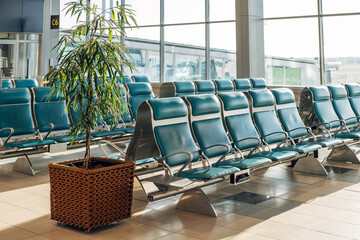 Waiting area with blue seats in new airport terminal.