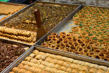 Trays of baklava, a layered pastry dessert made of filo pastry, filled with chopped nuts, and sweetened with syrup or honey.