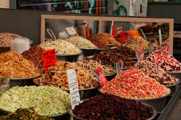 Colorful bins of specialty fruit tea blends.