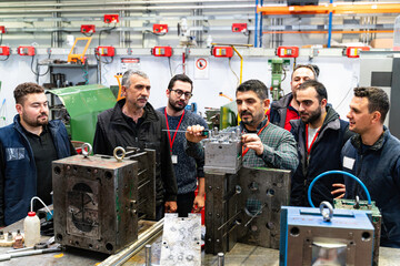 Males Industrial Engineers in Discuss New Project or planning investment project working and strategy. business making conversation at Industrial injection molding factory concept.