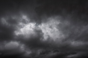 Dramatic dark storm rain clouds black sky background. Dark thunderstorm clouds rainny atmosphere. Meteorology danger windstorm disasters climate. Dark cloudscape storm disaster gloomy gray cloud sky