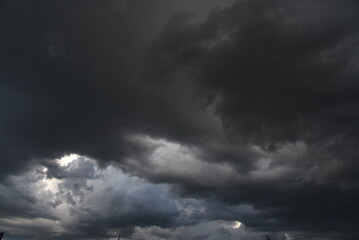 Fototapeta premium Dramatic dark storm thundercloud rain clouds on black sky background. Dark thunderstorm clouds rainny landscape. Meteorology danger windstorm disaster climate. Dark cloudscape storm disaster gray sky