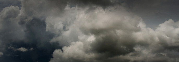 Banner Dramatic dark storm clouds black sky background. Dark thunderstorm clouds rainny season. Panorama Meteorology danger windstorm disasters climate. Dark cloudscape storm cloud with copy space.
