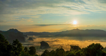 Sunset mountain range beautiful landscape mist foggy sunrise beam. Golden sky Mountain landscape foggy windy mountain. Amazing Landscape cloud sky on sunrise. Countryside gold sunlight heaven scene