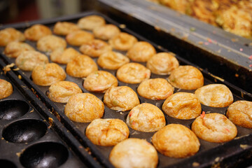 Takoyaki is a Japanese dish made by putting octopus in a flour batter and baking it
