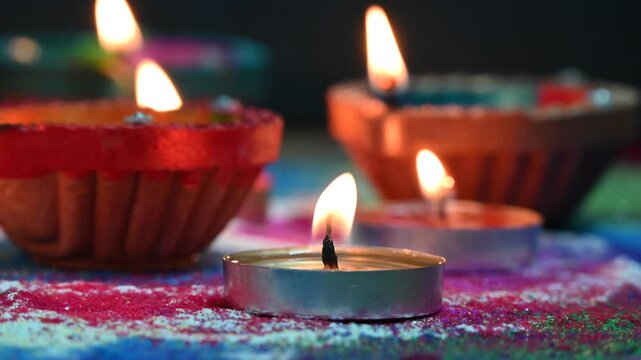 Clay diya lamps lit during diwali celebration. Indian festival Diwali, Diya oil lamps lit on colorful rangoli. Hindu traditional.