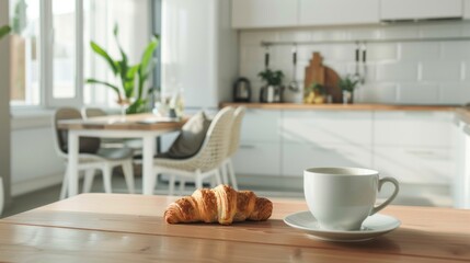 Obraz premium White coffee cup with a croissant on a plate