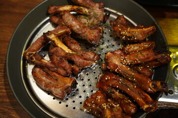 Boiled pork back ribs seasoned and grilled. The meat on the bone is chewy and delicious