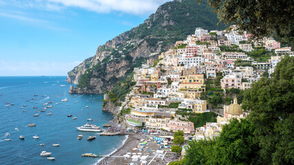 Breathtaking view of Positano along the Amalfi Coast with boats resting in crystal-clear waters